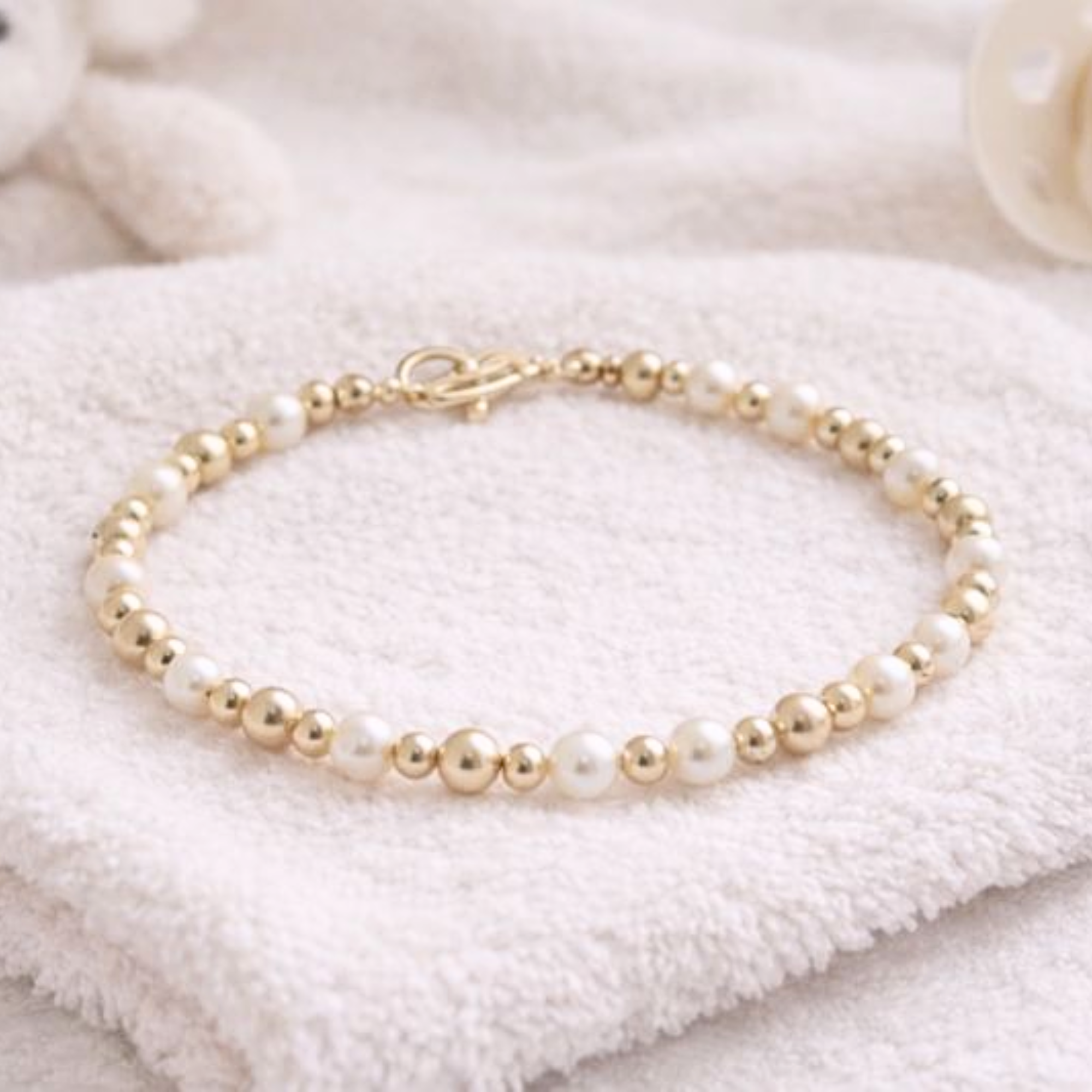Newborn pearl and gold bracelet