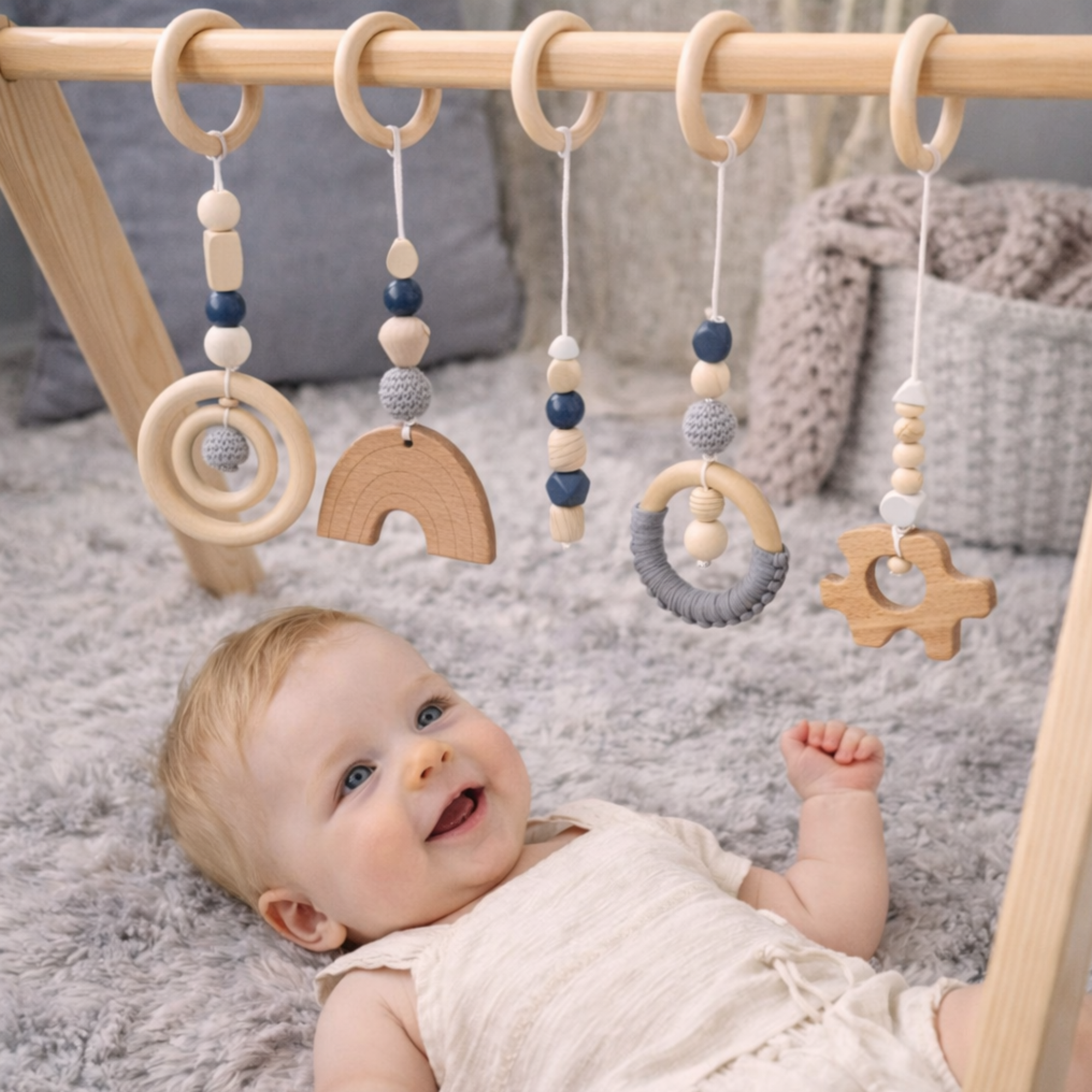 wooden hanging baby toy set made from natural beech wood with high-contrast shapes, BPA-free and eco-friendly, suitable for pram, activity gym or nursery, presented in gift box.